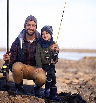 Buy stock photo Portrait, son and father with fishing, smile and happiness for bonding on break. Child, water and ocean with rocks, adventure and vacation on nature trip with childhood memories and parent fun