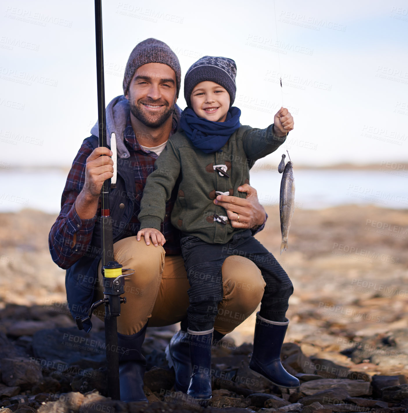 Buy stock photo Portrait of a cute little boy holding the fish he caught with his dad