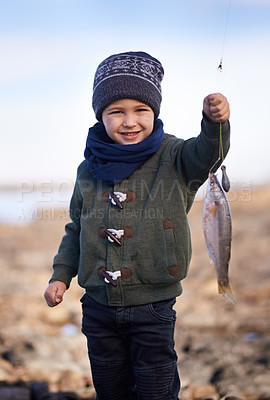 Buy stock photo Portrait of a cute little boy holding the fish he caught