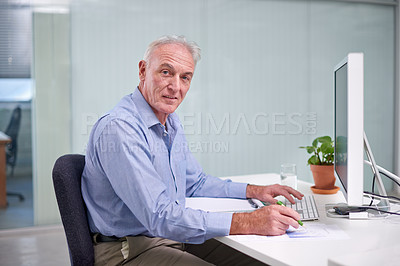 Buy stock photo Portrait of a mature businessman working at his office desk