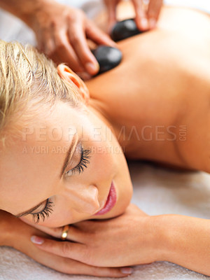Buy stock photo Woman, massage and relax in spa for hot stone, wellness and physical therapy for body, detox and luxury. Young person with eyes closed for rest and break for care, peace and treatment for holiday 