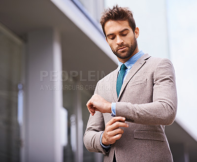 Buy stock photo Person, professional and businessman in formal or smart suit and in city background. Travel worker or corporate employee, entrepreneur and male fashion model fixing long sleeve outdoors downtown