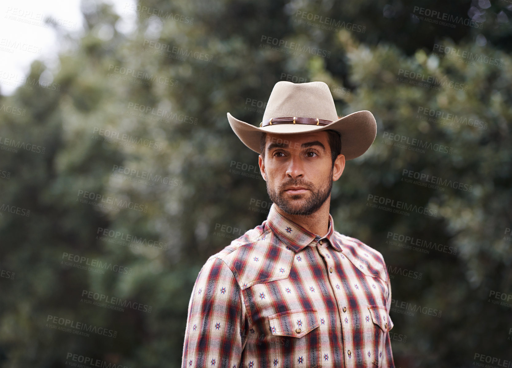 Buy stock photo Man, hat and outdoor cowboy fashion, western culture and countryside ranch in Texas. Male person, accessory and flannel shirt for farmer aesthetic, nature and plaid style by trees or outside bush