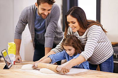 Buy stock photo Cooking, pizza and family in kitchen with tablet for recipe, guide and mom and dad learning with child. Teaching, baking and girl helping parents with rolling pin in home and together for dinner