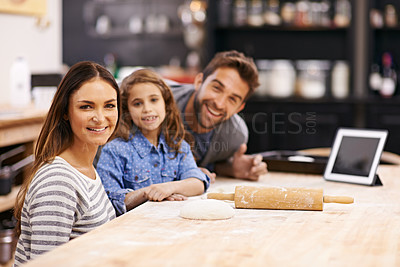 Buy stock photo Portrait, mother and father with child to bake in a kitchen teaching for help, support or learning in home. Family, tablet or girl cooking bread with parents, dad and mom for dinner, supper or lunch