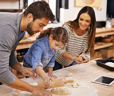 Buy stock photo Pizza, dough and parents with child in kitchen and tablet for recipe, guide and learning together. Family, cooking and girl help with rolling pin and baking with dad and mom in home for dinner