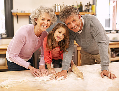 Buy stock photo Cooking, smile or portrait of grandparents with child in kitchen teaching for support or learning in home. Family, baking or girl with dough, grandma or elderly grandfather for dinner, pizza or lunch
