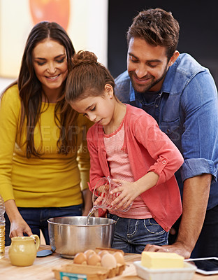 Buy stock photo Parents, girl and kitchen for baking with love, ingredients for cake or dessert with support and handmade with care. Mom, dad and kid together in family home for bonding or teaching with affection.