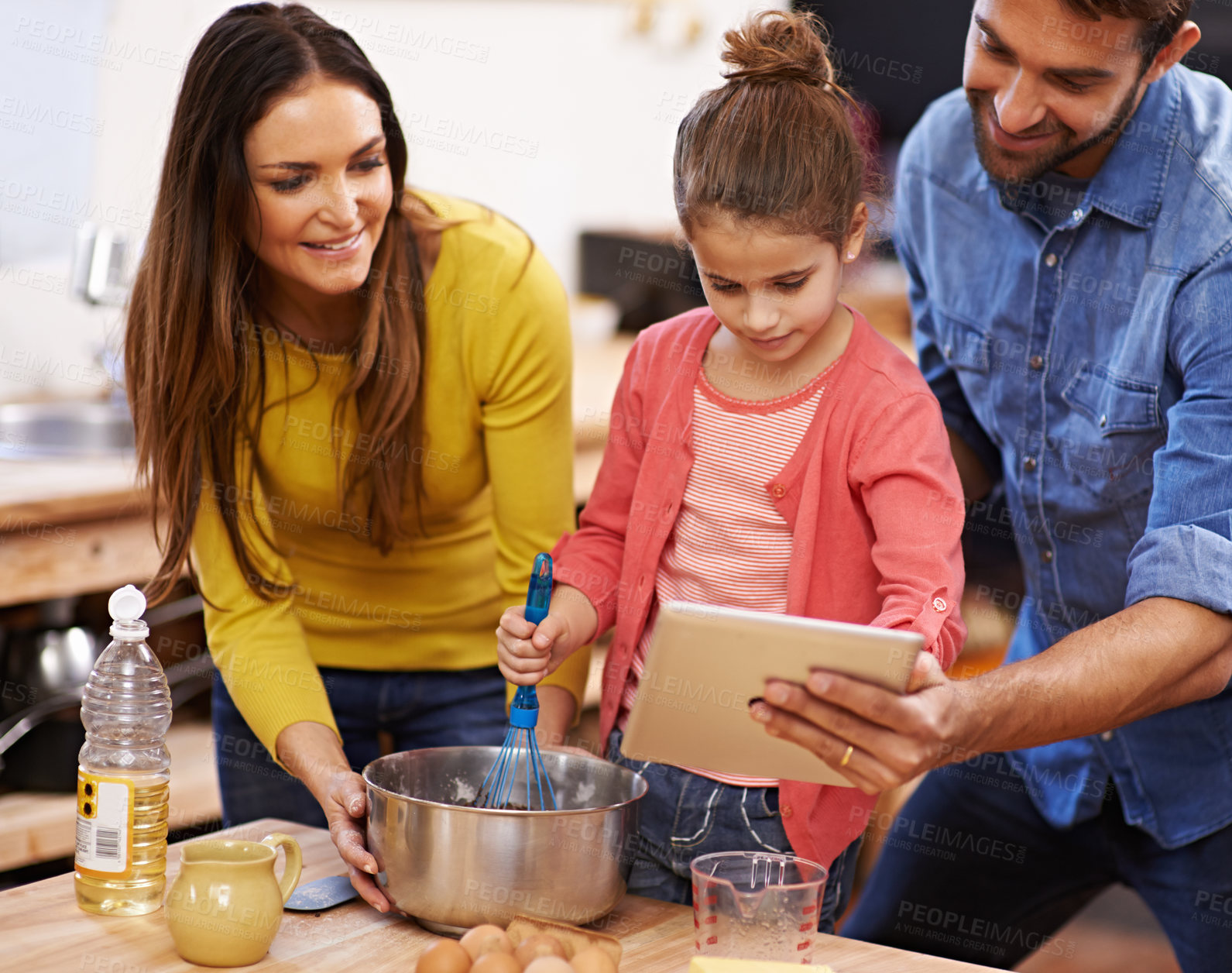 Buy stock photo Family, kitchen and baking with tablet for recipe online with ingredients for cake or dessert with support and handmade. Mom, dad and girl child cooking together with love for bonding or teaching.