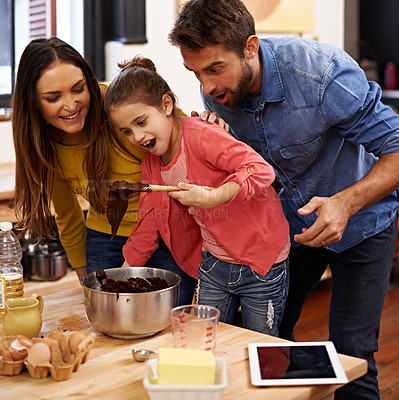 Buy stock photo Shot of a happy family baking together in the kitchen