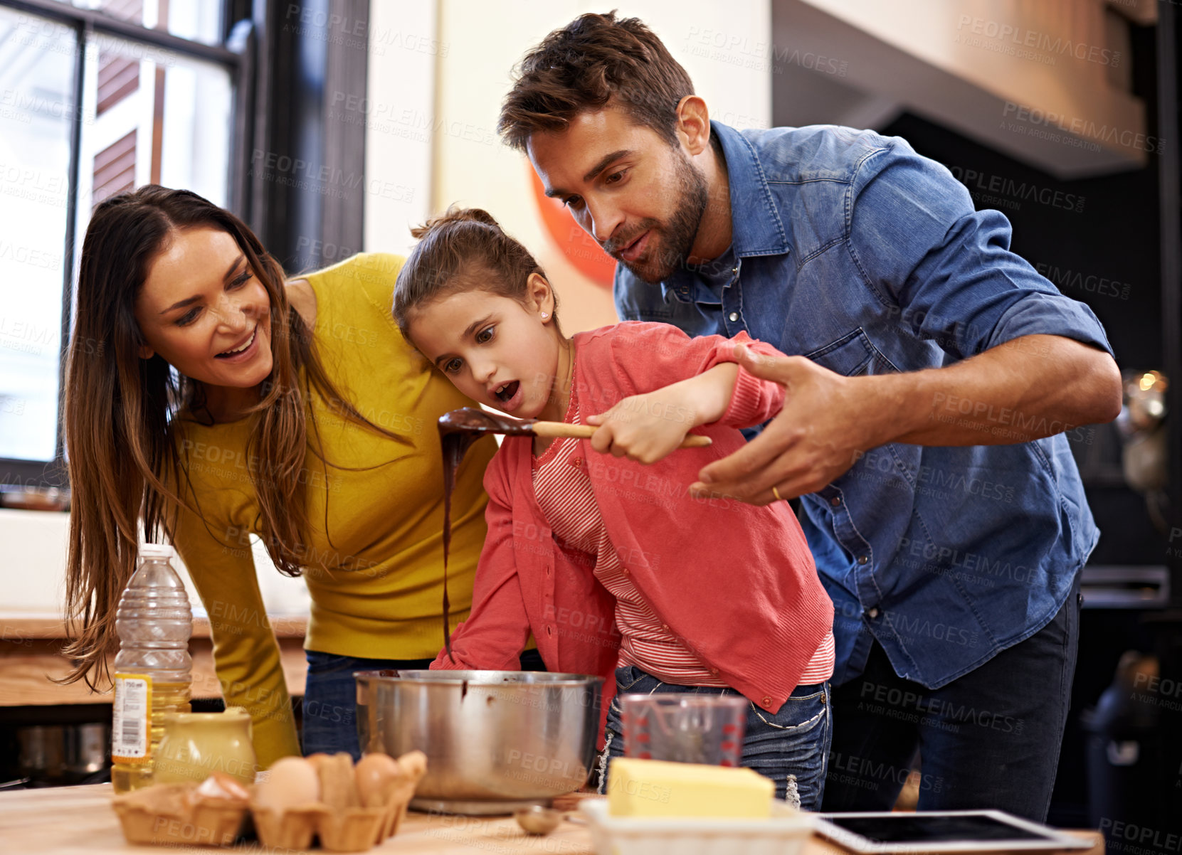Buy stock photo Parents, girl and kitchen for baking with love, ingredients for cake or dessert with support and handmade with care. Mom, dad and kid with wow face for mixture with bonding or teaching with affection