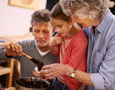 Buy stock photo Help, grandparents and baking with girl, kitchen and home with happiness and bonding together with recipe. Family, grandchild and old man with senior woman and hobby with utensils, food and taste
