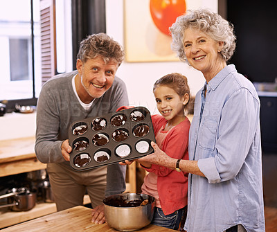 Buy stock photo Girl, grandparents and portrait with cupcakes, kitchen and baking together. Mature couple, smile and child for happiness, love and learning at home with grandmother for childhood memories and family