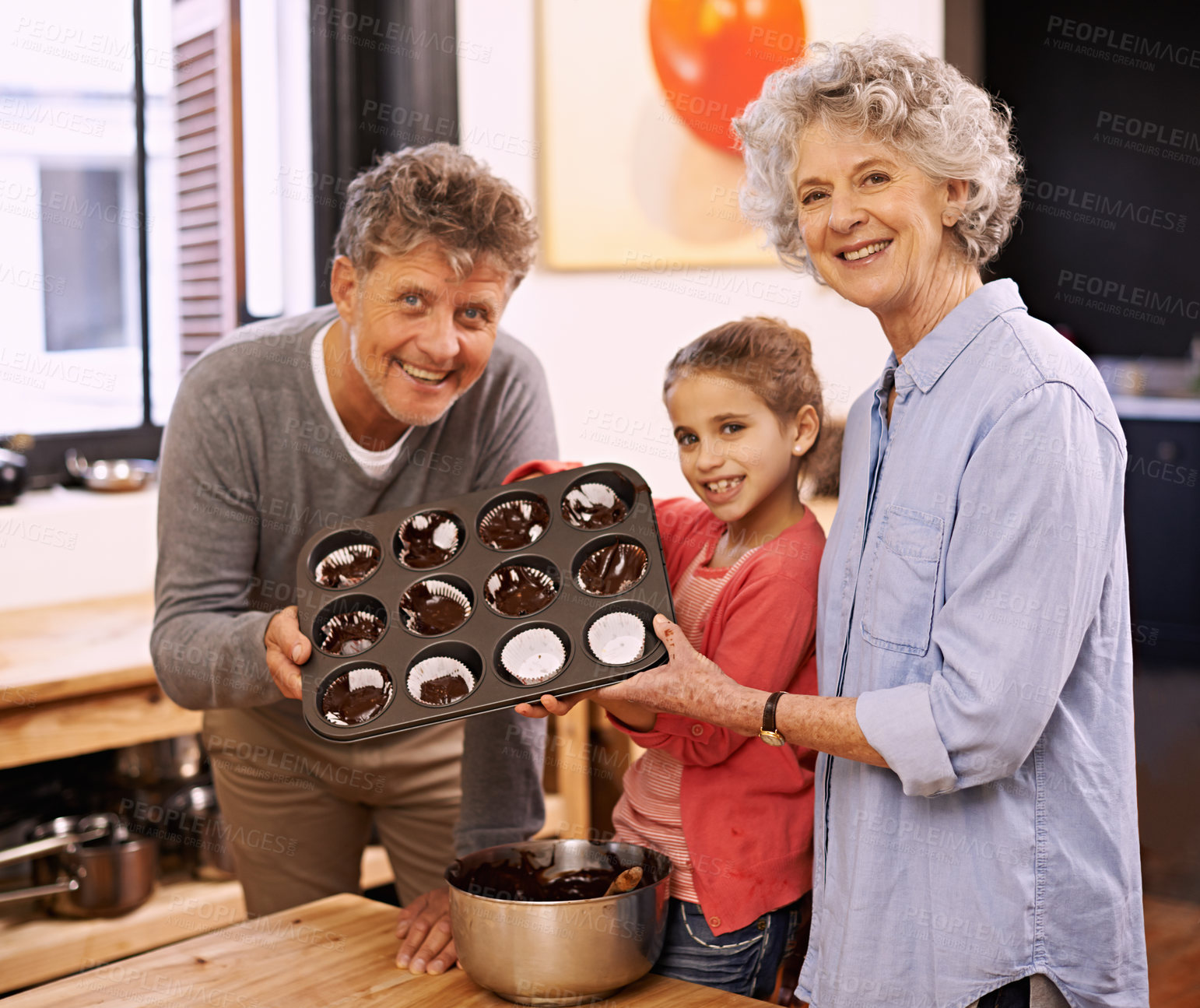Buy stock photo Girl, grandparents and portrait with cupcakes, kitchen and baking together. Mature couple, smile and child for happiness, love and learning at home with grandmother for childhood memories and family