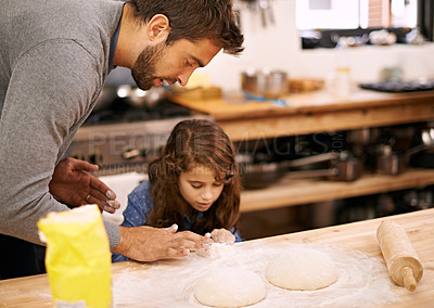 Buy stock photo Shot of a father and daughter working with pizza dough in the kitchen