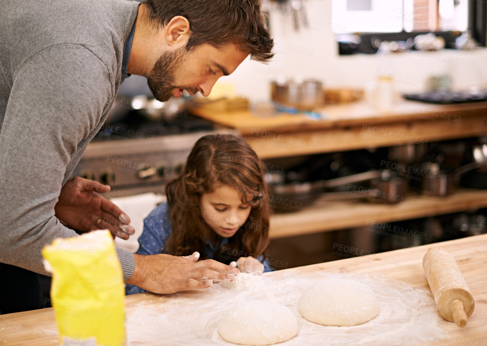 Buy stock photo Shot of a father and daughter working with pizza dough in the kitchen