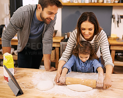 Buy stock photo Family, cooking and learning in kitchen with tablet for recipe, guide and parents with child in home. Baking, mom and dad helping girl with rolling pin and talking about pizza, dinner or meal prep