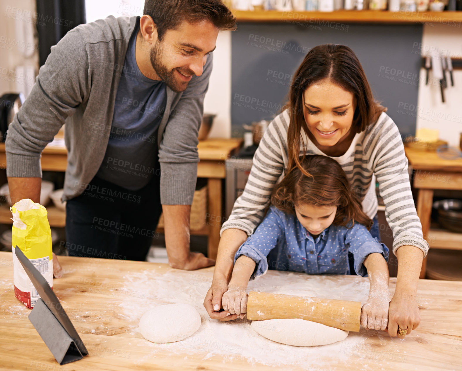 Buy stock photo Family, cooking and learning in kitchen with tablet for recipe, guide and parents with child in home. Baking, mom and dad helping girl with rolling pin and talking about pizza, dinner or meal prep