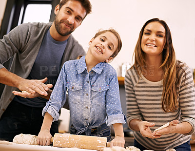 Buy stock photo Portrait, mother and father baking with child in a kitchen teaching for help, support or learning in home. Family, smile or girl cooking bread with parents, dad and mom for dinner, pizza or lunch