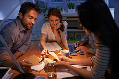 Buy stock photo Shot of a group of young business professionals having a meeting