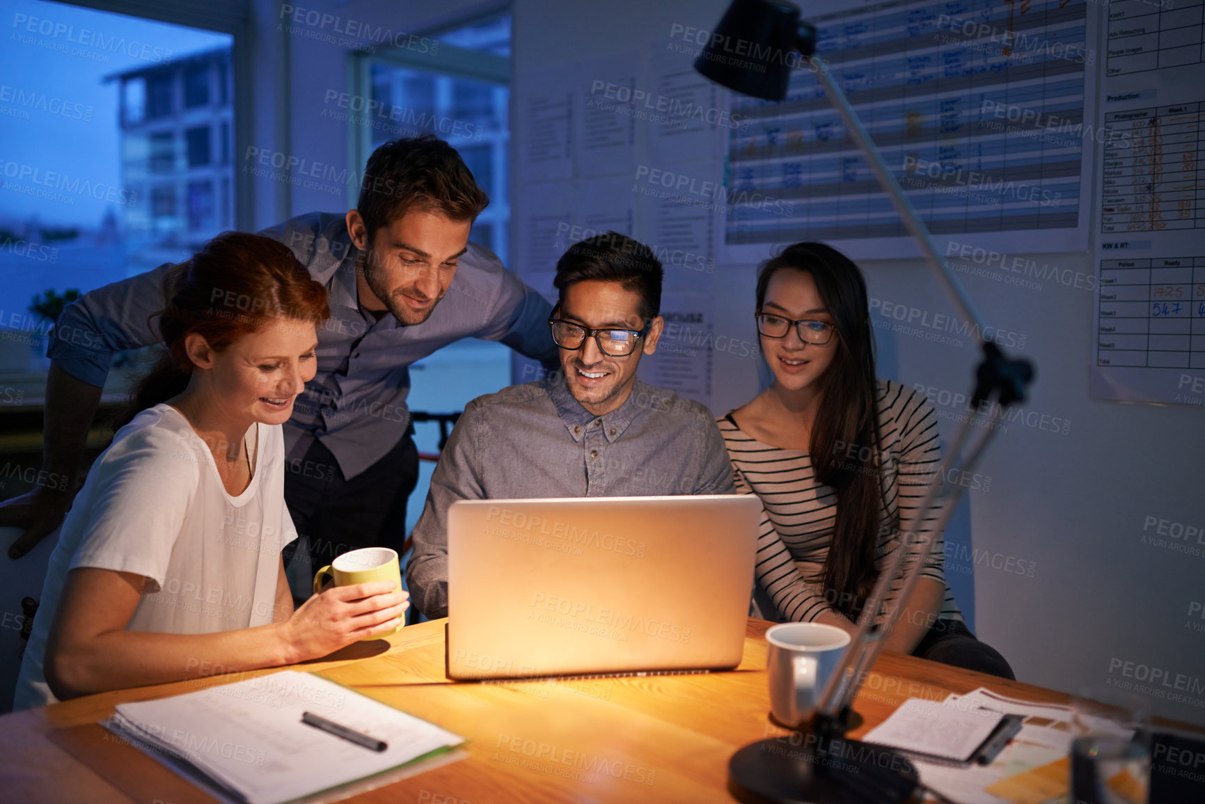 Buy stock photo Collaboration, night and an employee team on a laptop, working in the boardroom for planning, strategy or innovation. Meeting, teamwork and overtime with a business group at work in the evening