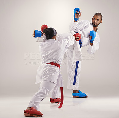 Buy stock photo People, karate and kick to practice in studio on white background with focus to fight or train for competition. Mma, sport and glove for fitness with technique, commitment and confidence as fighter