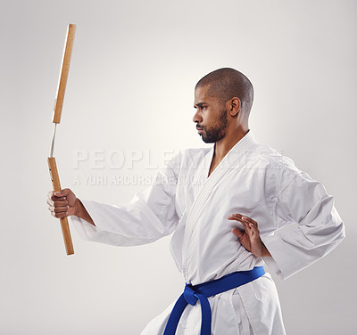 Buy stock photo Nunchaku, karate and man in martial arts fight with weapon in training for defence in white background of studio. Nunchucks, exercise and fighting with equipment in sport or gym with creative skill