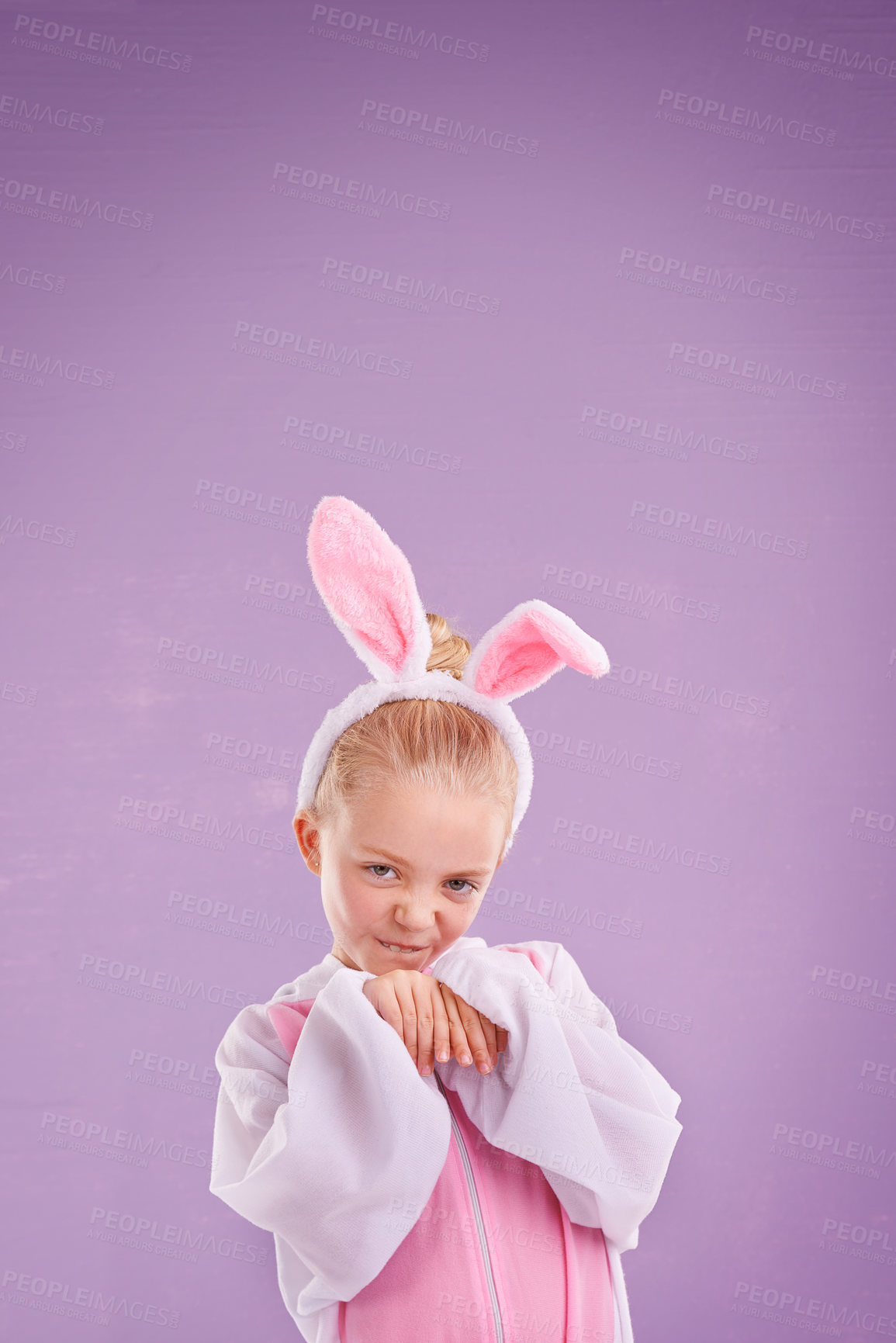 Buy stock photo Portrait, rabbit and girl with costume, happy and Halloween outfit on a purple studio background. Face, kid and model with bunny clothes and character with holiday and easter with culture and funny