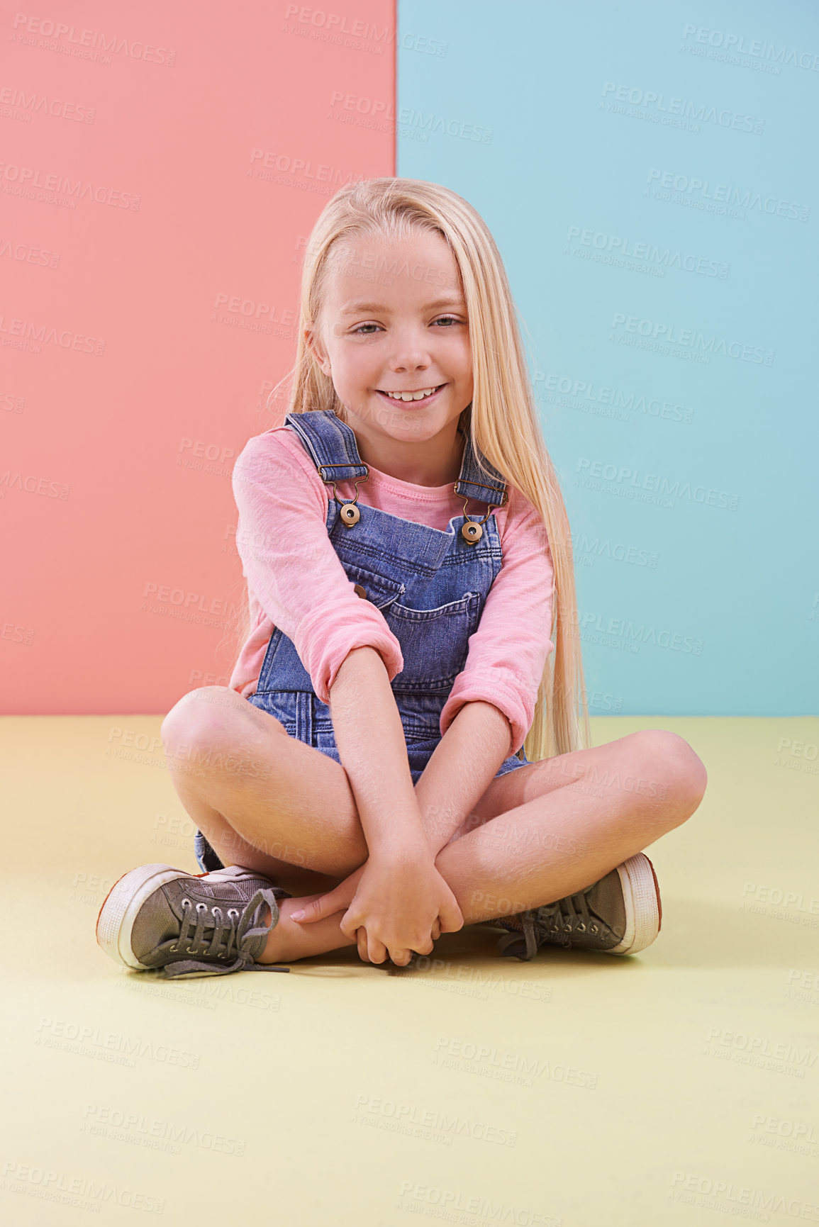 Buy stock photo Portrait, smile and girl on the floor, kid and happiness on a colorful studio background. Model on the ground, mockup space and child with joy and relaxing with break and cheerful with fun and peace