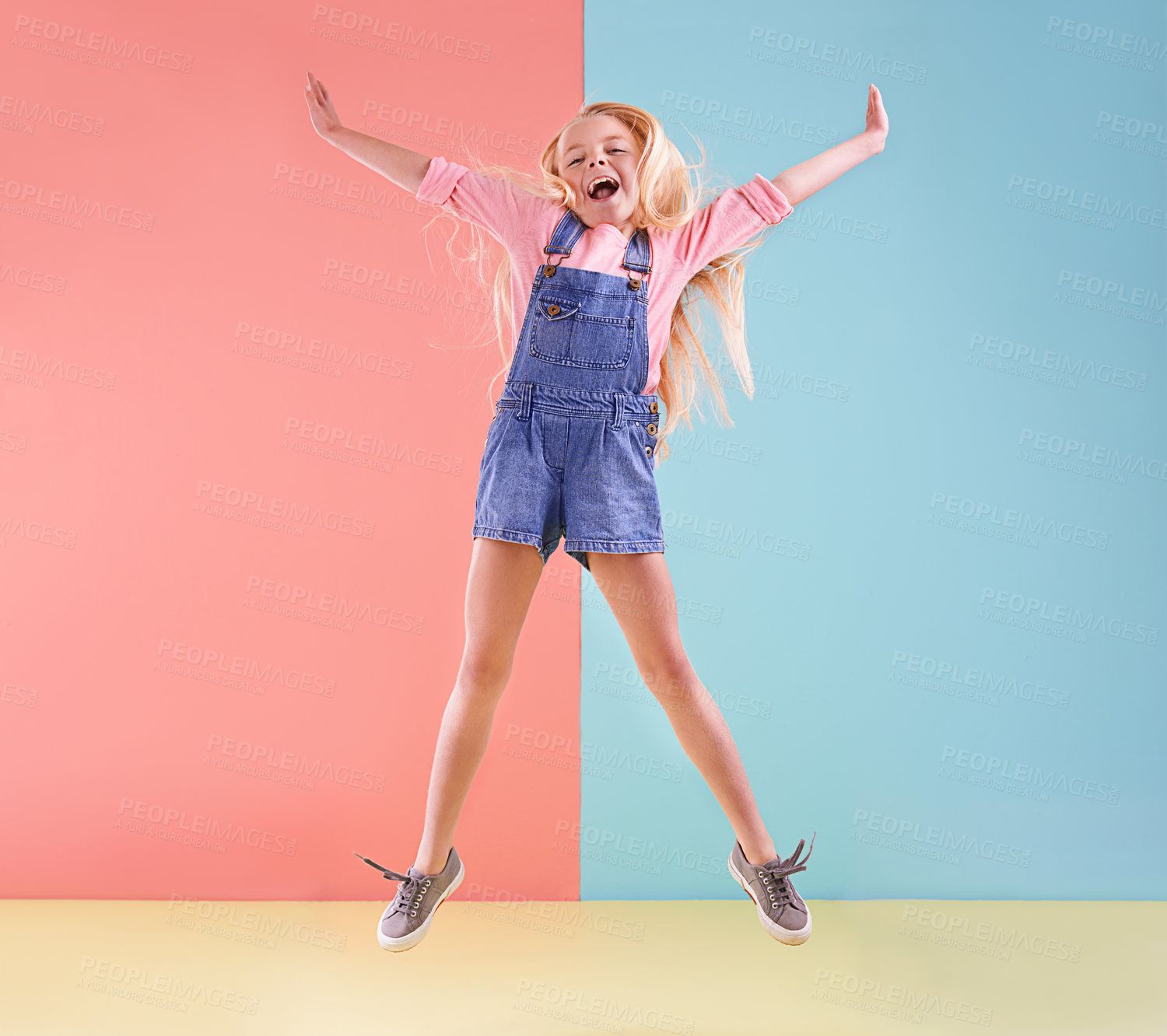 Buy stock photo A cute little girl jumping against a colorful background