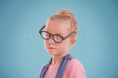 Buy stock photo Child, portrait and eye glasses vision in studio for optometry healthcare for youth development, blue background or mockup space. Female person, kid and eyewear for spectacle frame, sight or lens