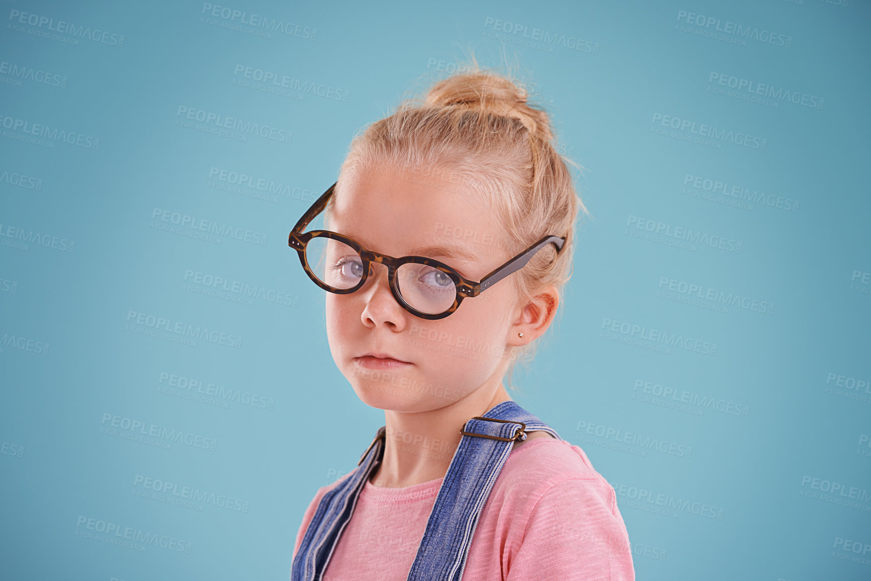 Buy stock photo Child, portrait and eye glasses vision in studio for optometry healthcare for youth development, blue background or mockup space. Female person, kid and eyewear for spectacle frame, sight or lens