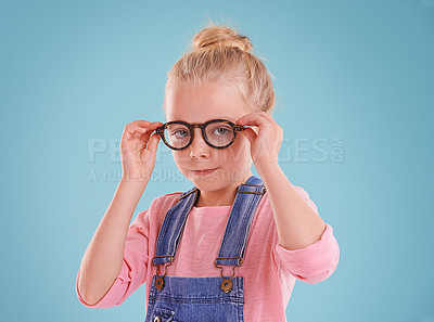 Buy stock photo Child, portrait and eye glasses optometry in studio or healthcare vision for youth development, blue background or mockup space. Female person, kid and eyewear for spectacles frame, sight or lens