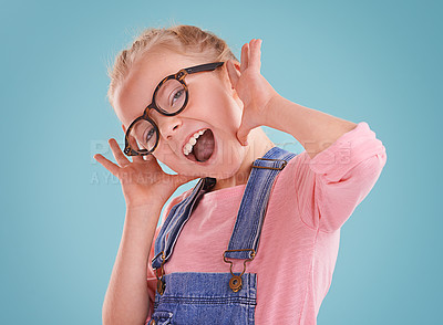 Buy stock photo Studio shot of a little girl wearing hipster glasses on a blue background