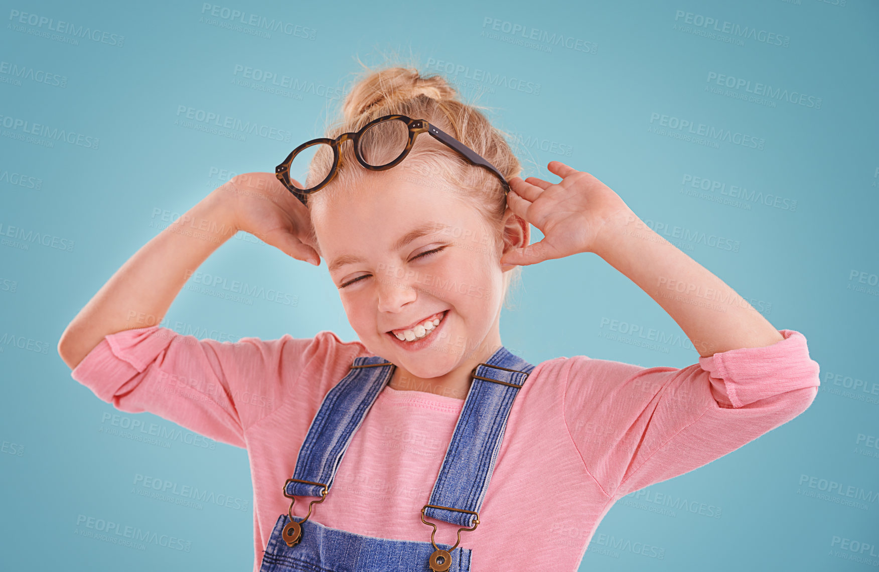Buy stock photo Child, happy and eye glasses in studio or healthy vision or optometry prescription, mockup space or blue background. Female person, kid and smile with spectacle frames for wellness, lens or optical