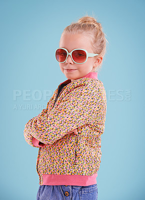 Buy stock photo Child, portrait and fashion with sunglasses in studio for trendy, cool and funky style with confidence. Cute girl, smile and happy in blue background, young kid and retro clothes with glasses