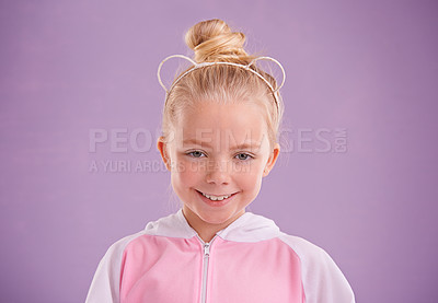 Buy stock photo Child, smile and portrait in studio with accessory for ears, young and growing up for adolescent, innocent and purple.  Little girl or kid and happy for junior, childhood and children for cute joy