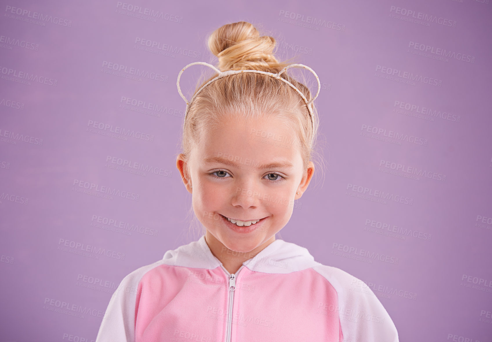 Buy stock photo Child, smile and portrait in studio with accessory for ears, young and growing up for adolescent, innocent and purple.  Little girl or kid and happy for junior, childhood and children for cute joy