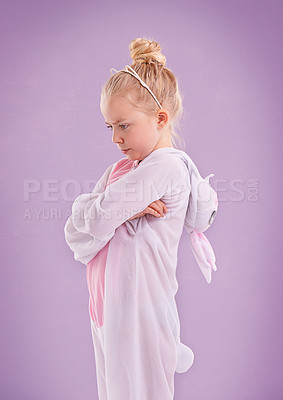 Buy stock photo Girl, bunny and costume with attitude, studio and arms crossed for easter. Child, plush and youth with pastel, rabbit and grumpy for holiday with childhood dress up isolated on purple background