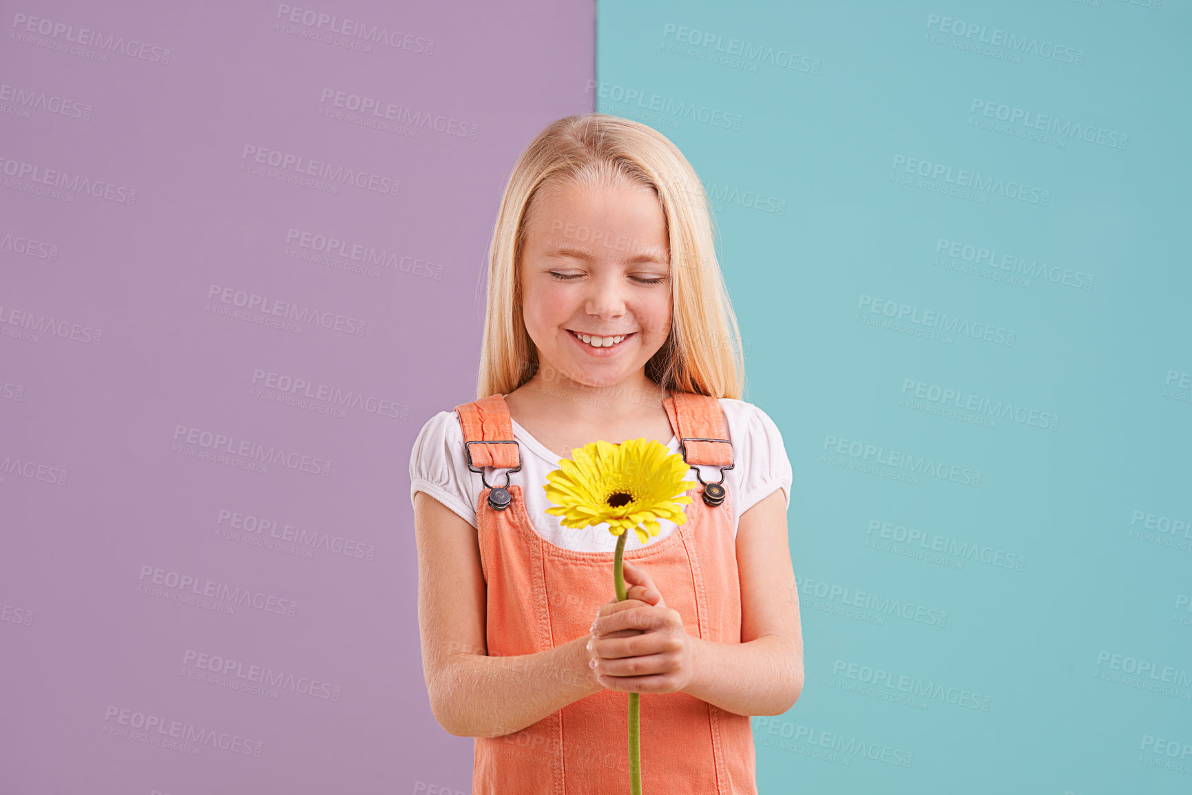 Buy stock photo Style, flower and child with wish in studio with cute, trendy and casual dress for outfit. Sweet, smile and young girl kid with fashion and yellow floral plant for gift by color block background.