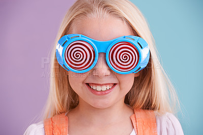 Buy stock photo Child, studio and colour with fashion glasses, happy smile on girl with hypnotic cute eyewear. Groovy, funky and playful hipster style, trendy kid with cool vibrant bright pattern for accessories