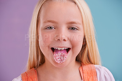 Buy stock photo Child, portrait and tongue out in studio for crazy, silly and playful facial expression with color block background. Happy, goofy and funny face of young girl for comic, humor and joking by sprinkles