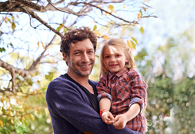 Buy stock photo Happy, hugging and faces of father and daughter under tree in garden for smile, bonding or affectionate. Portrait, relax and excited with man and young girl in outdoors for embrace, autumn and care