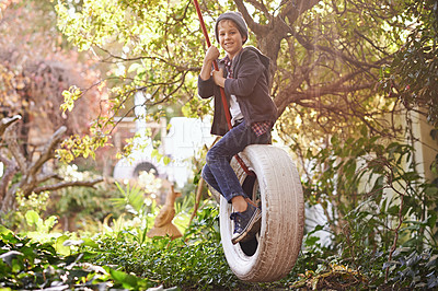 Buy stock photo Boy, tyre swing and portrait in garden with happiness, playing and countryside vacation in summer. Child, face and diy adventure playground in backyard of home with sunlight, trees or smile in nature