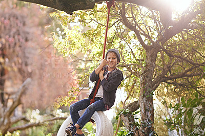 Buy stock photo Boy, tyre swing and portrait in garden with happiness, playing and countryside vacation in summer. Child, face and diy adventure playground in backyard of home with sunlight, trees or smile in nature