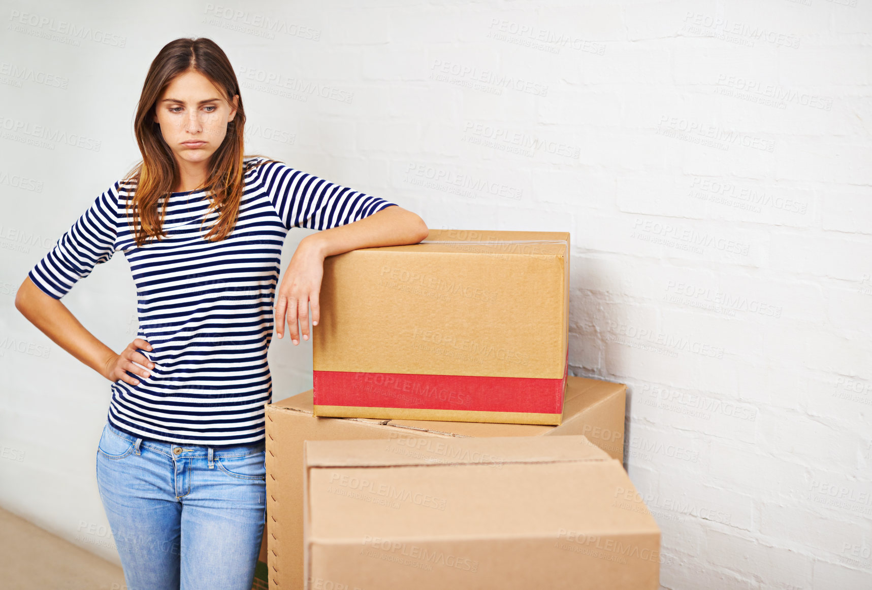 Buy stock photo Shot of an attractive young woman busy moving house
