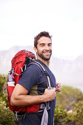 Buy stock photo Shot of a young man enjoying a hike through the mountains