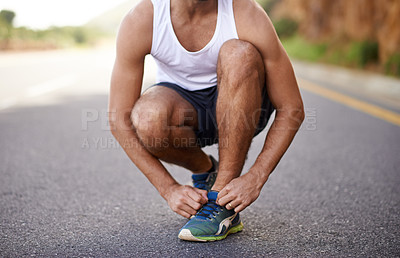 Buy stock photo Man, feet and tying laces on road for running, prepare and shoes for cardio or training for marathon. Male person, legs and fitness on mountain street for performance, athlete and ready for exercise