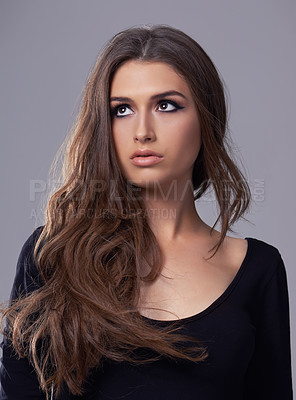 Buy stock photo Studio shot of a gorgeous young woman against a gray background