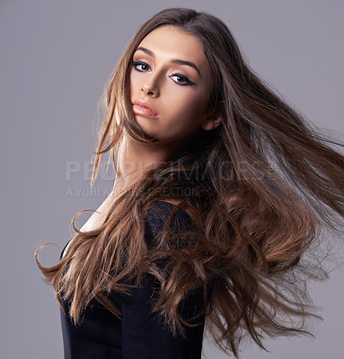 Buy stock photo Studio portrait of a gorgeous young woman against a gray background